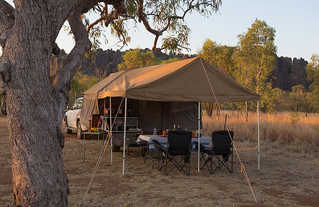 A camper trailer set up with the awning extended
