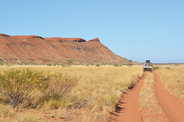 Car driving next to a hill