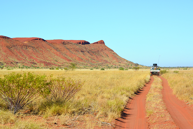 Car driving on long stretch of road