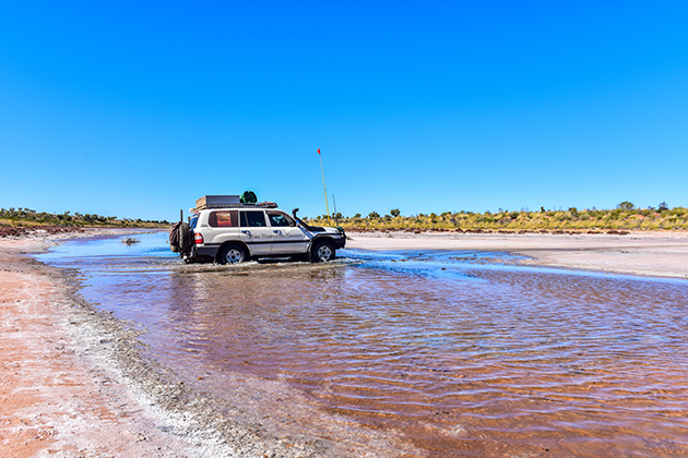 Car driving over water