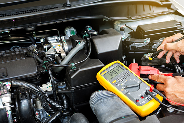 Person testing a car battery