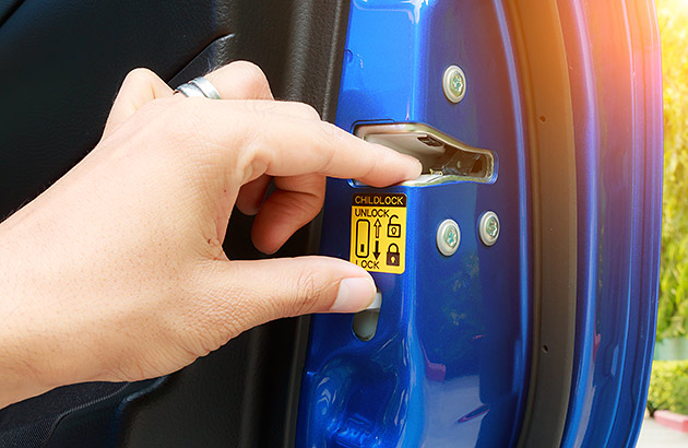 Hand on a child car lock