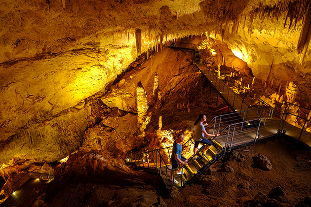 People walking up stairs in a cave