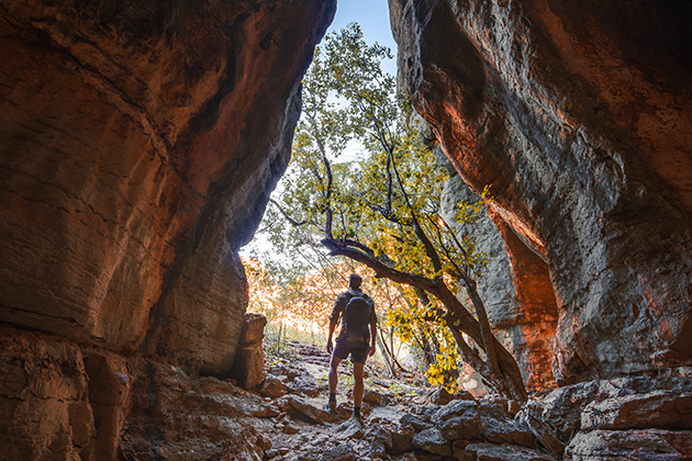Man standing in cave entryway