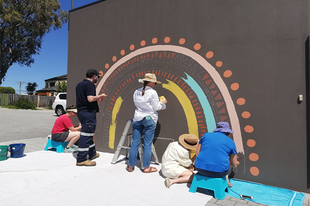 Image of people painting a mural