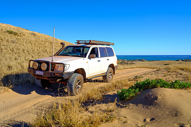 Four-wheel drive vehicle near the beach