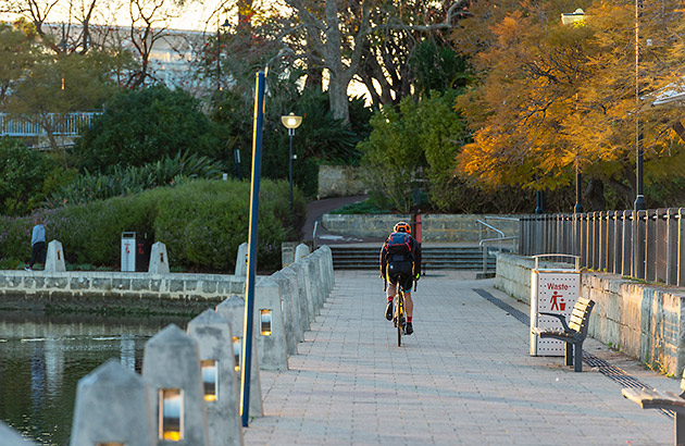 Cyclist riding along the riverfront