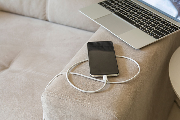 Phone charging on soft couch