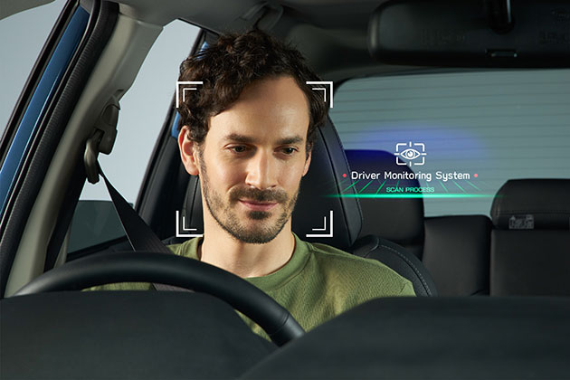 Man inside car with driver monitoring system enabled