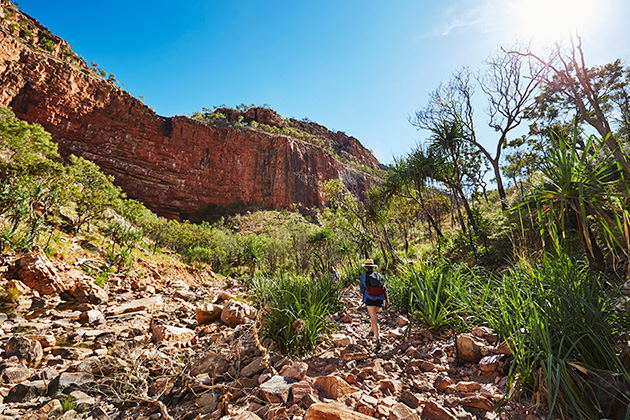 Woman hiking through a gorge