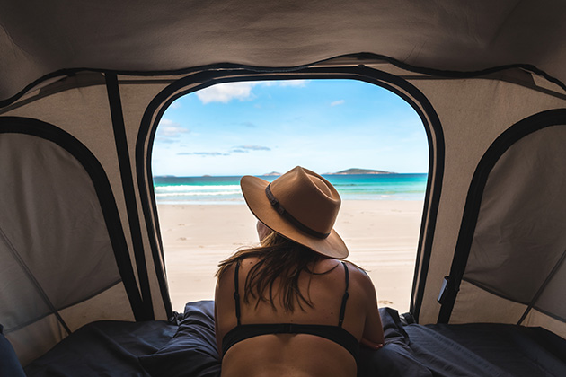 Woman camping on the beach