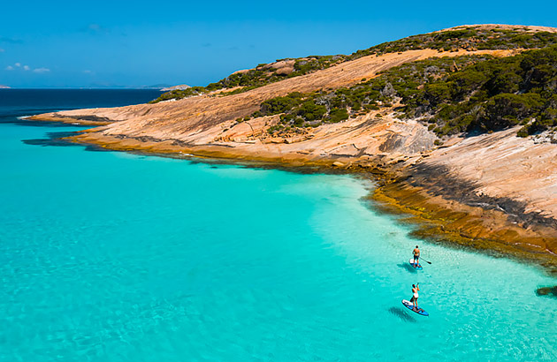 Two people paddling boarding along the Esperance coast