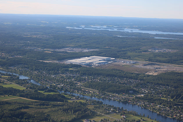 Aerial shot of river, fields and factory