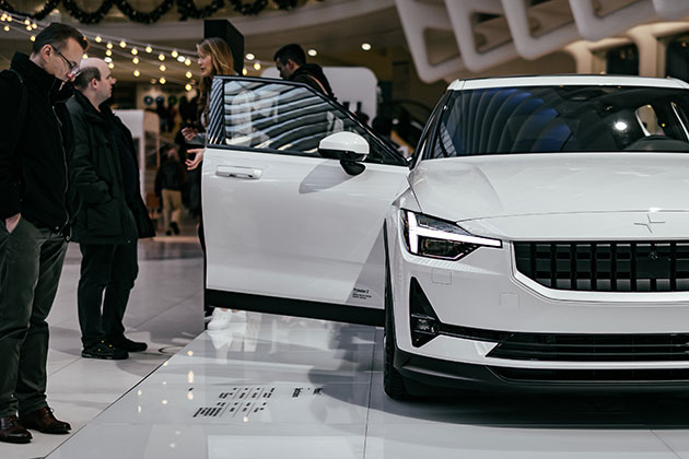 Man looking at a white car