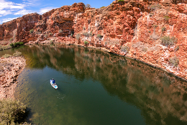 Man paddling down a creek