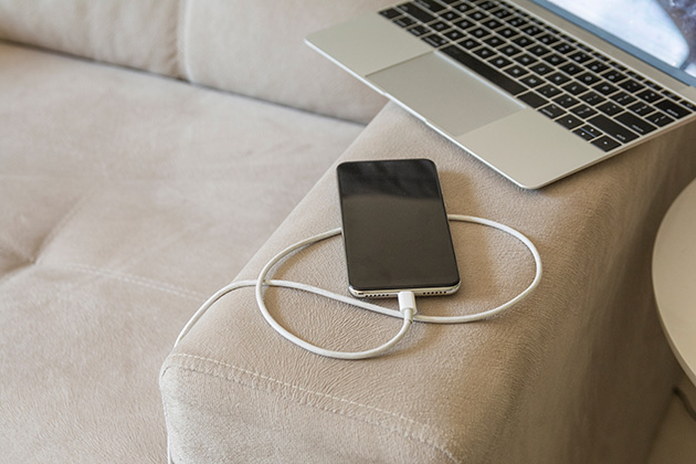 Phone charging on a soft couch