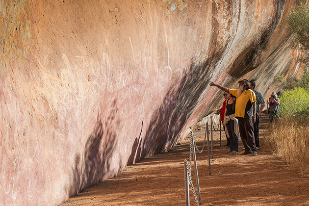 People looking at rock art