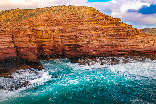 Red cliffs against ocean