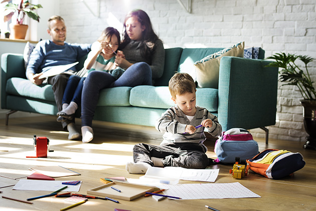 Family on couch and child on the floor