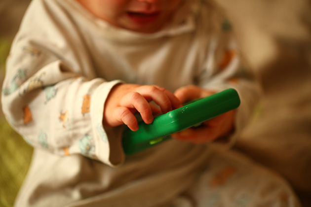 Baby playing with toy battery