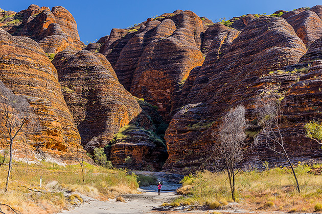 Person walking beneath Bungle Bungle Range