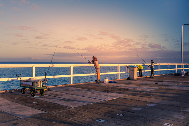 People fishing off jetty