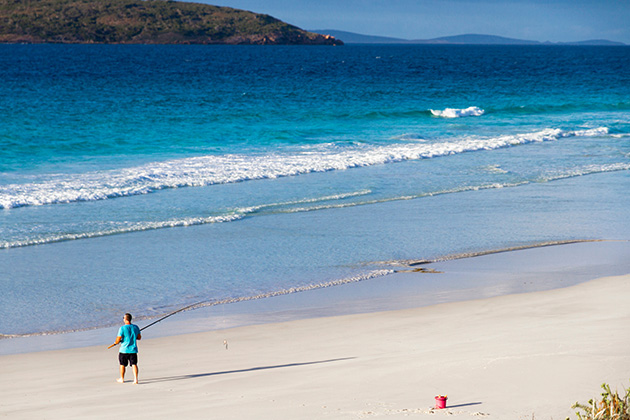 Person fishing off the beach