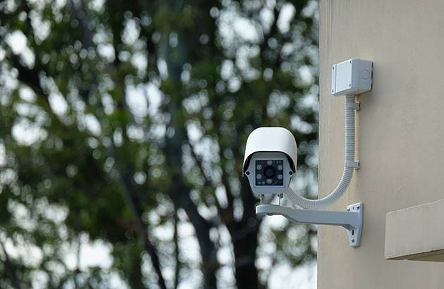 CCTV camera mounted to residential wall