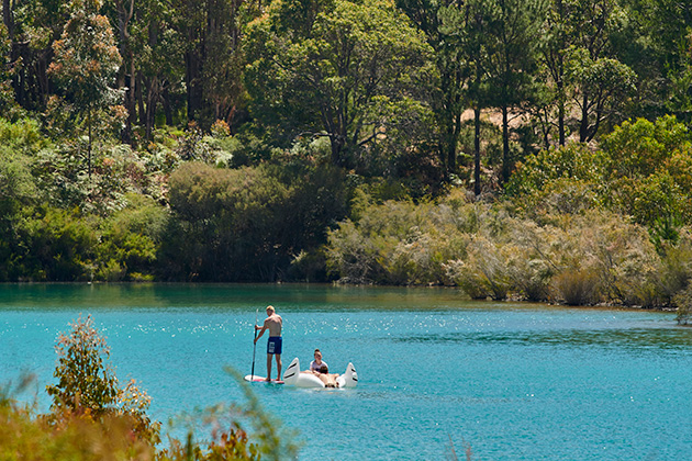 People floating on a blue lake