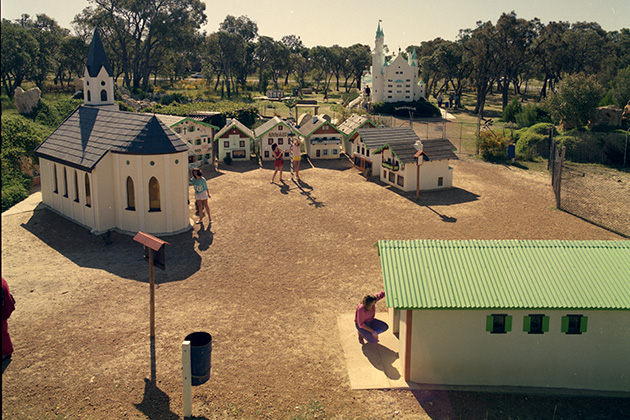 People walking through a miniature village