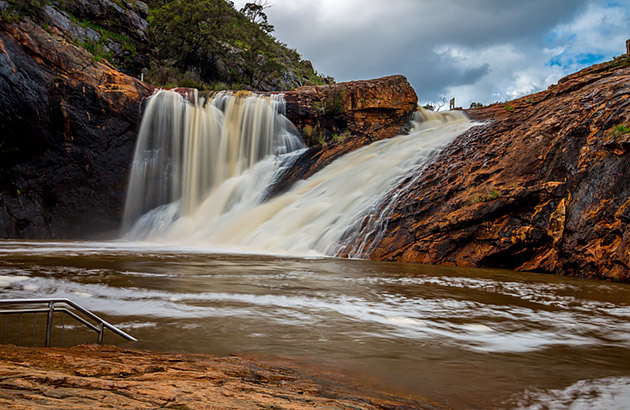 Falls flowing over a big rock