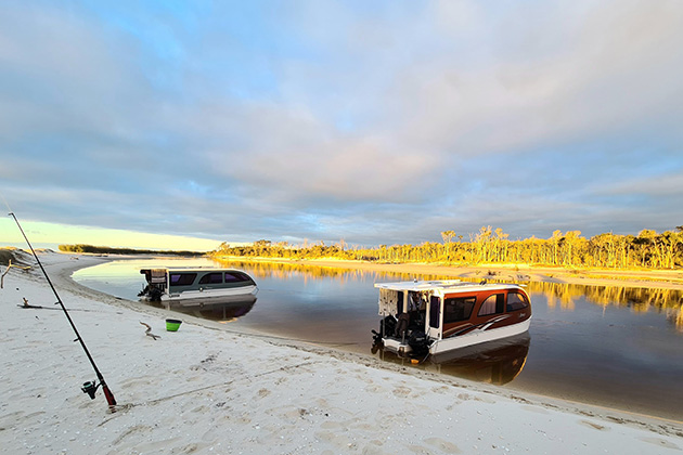 Caraboats next to fishing rods