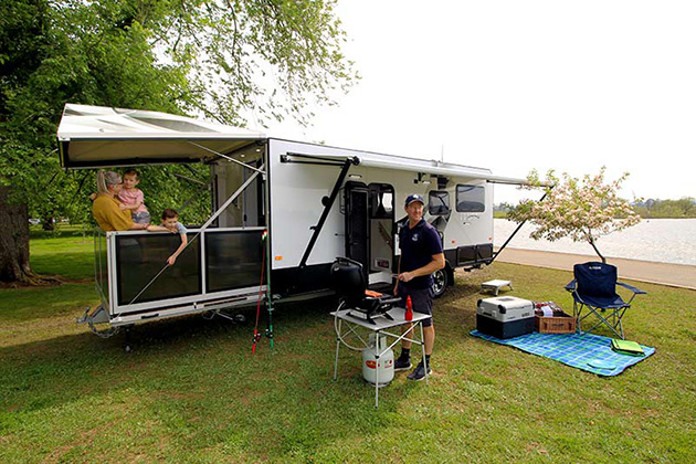 Family sitting on deck of a caravan