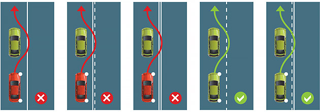 Red and green car crossing dividing lines on the road