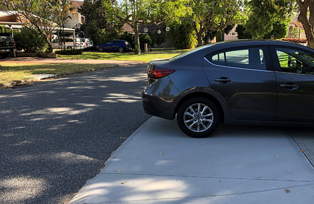 Car crossing over a footpath