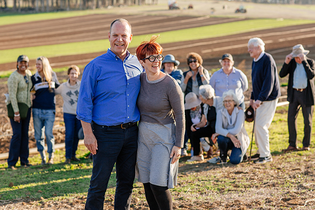 Two people standing in front of a group