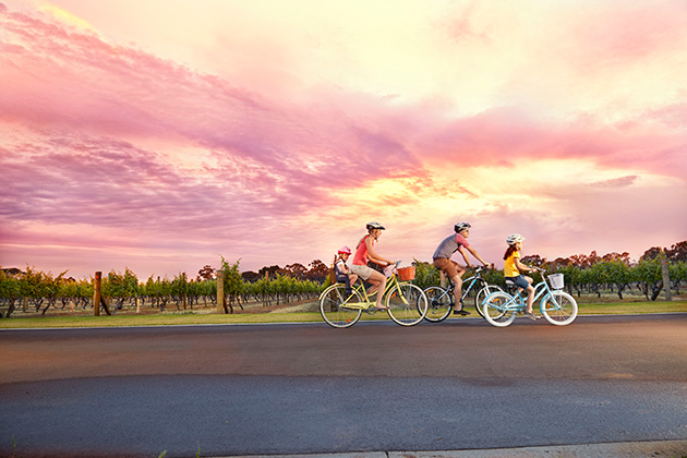 Family cycling at side of road