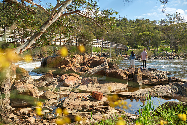 Couple walking near waterfall