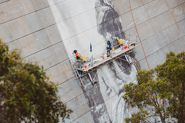 Two men painting on scaffolding