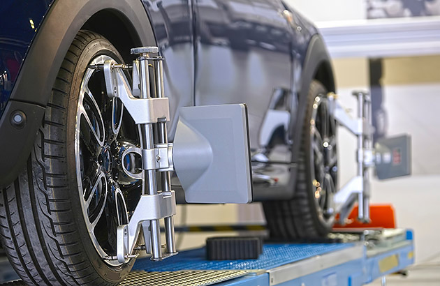 A car's wheels being aligned in a workshop