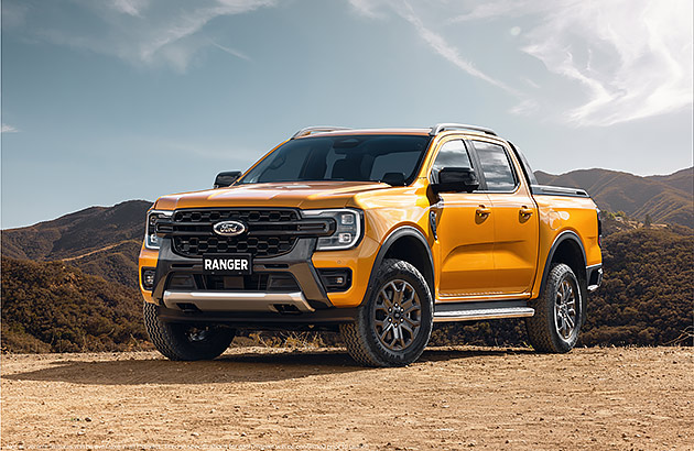 An orange Ford Ranger on a dirt road