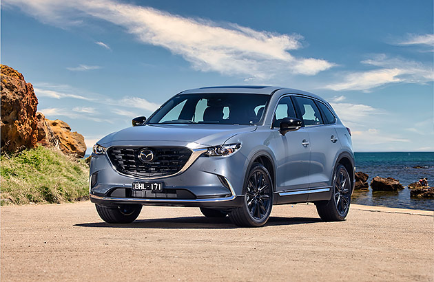 A Mazda CX-9 with ocean in the background