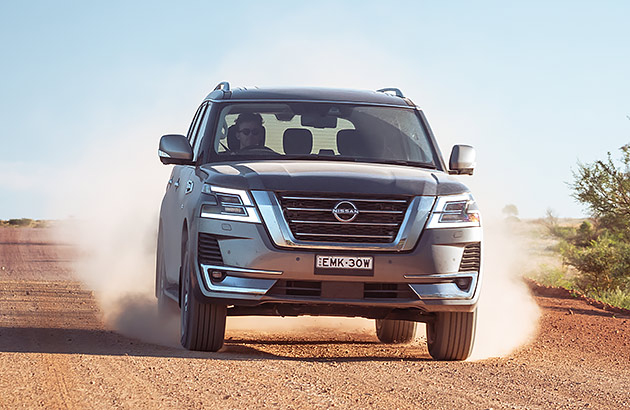 A Nissan Patrol driving on a dirt road