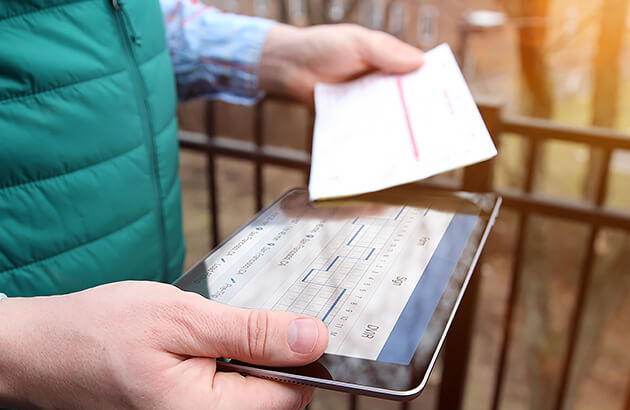 A person holding a car logbook