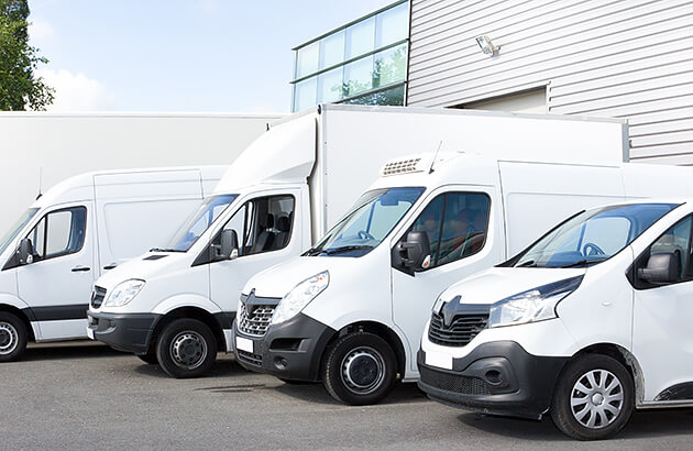 A fleet of white vans