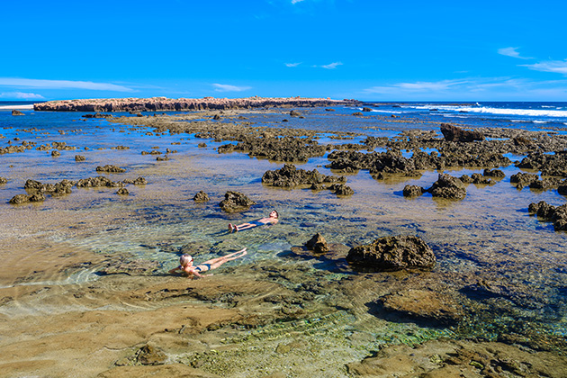 People sitting in rock pools