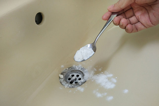 Teaspoon of baking soda over the sink