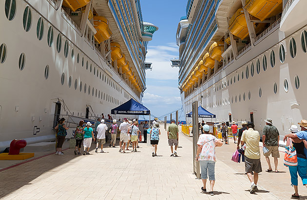 Passengers boarding cruise ships in a port