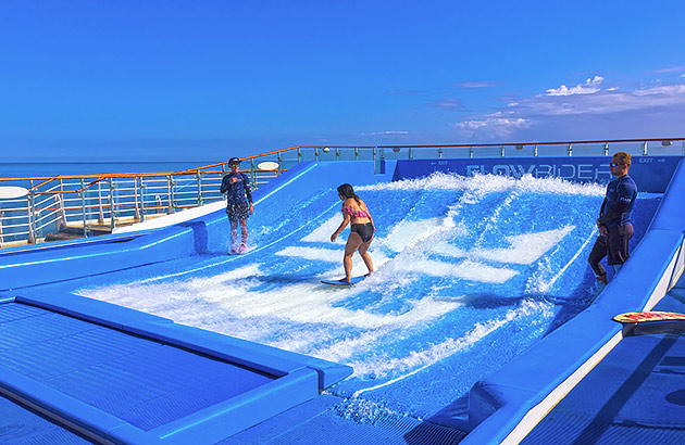 A surfing simulator with someone riding waves on board a ship