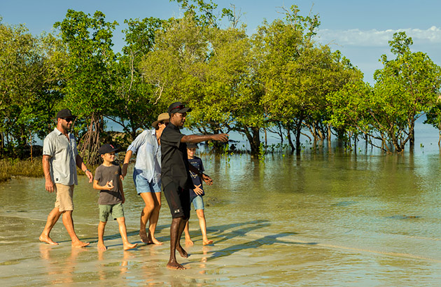 Family with tour guide on the beach
